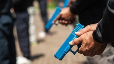 hands holding guns