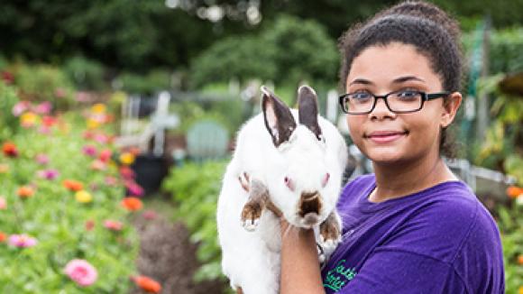 Girl with bunny in a garden