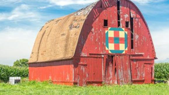 Red barn in front of a corn field