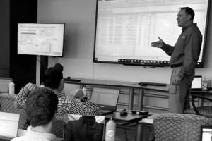Man presenting in front of a group.