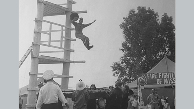 Man jumping from fire tower during fire training.
